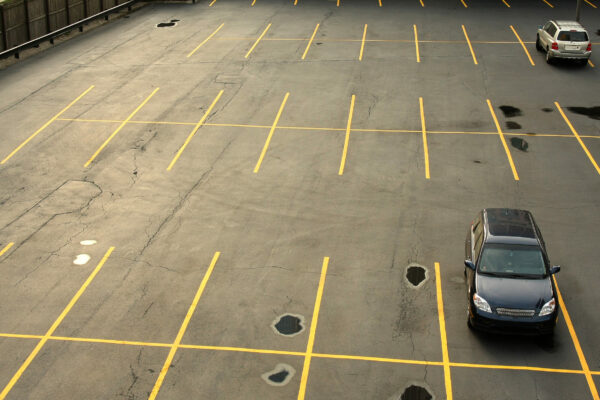 Aerial view of a parking lot with cars.